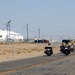 Marine and civilian personnel waved on veteran motorcycle riders with salutes and American flags along Route 66/Joseph L. Boll