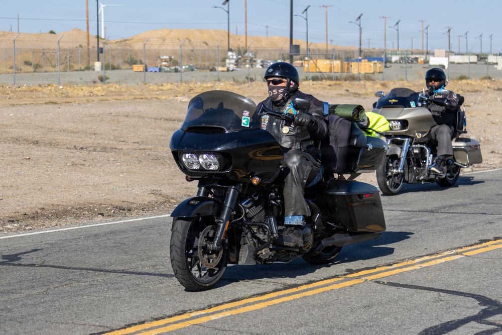 Marine and civilian personnel waved on veteran motorcycle riders with salutes and American flags along Route 66/Joseph L. Boll
