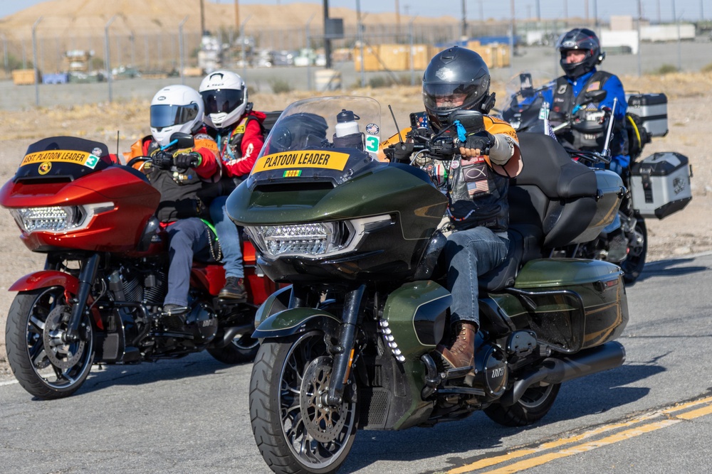 Marine and civilian personnel waved on veteran motorcycle riders with salutes and American flags along Route 66/Joseph L. Boll