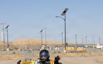 Platoon Leader Waves During Military Motorcycle Ride at Desert Installation