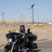 Platoon Leader Waves During Military Motorcycle Ride at Desert Installation