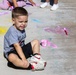 Young child reacts during outdoor painting activity for Earth Day event aboard MCLB Barstow's CDC