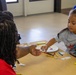 Child Participates in Arts and Crafts during Earth Day event