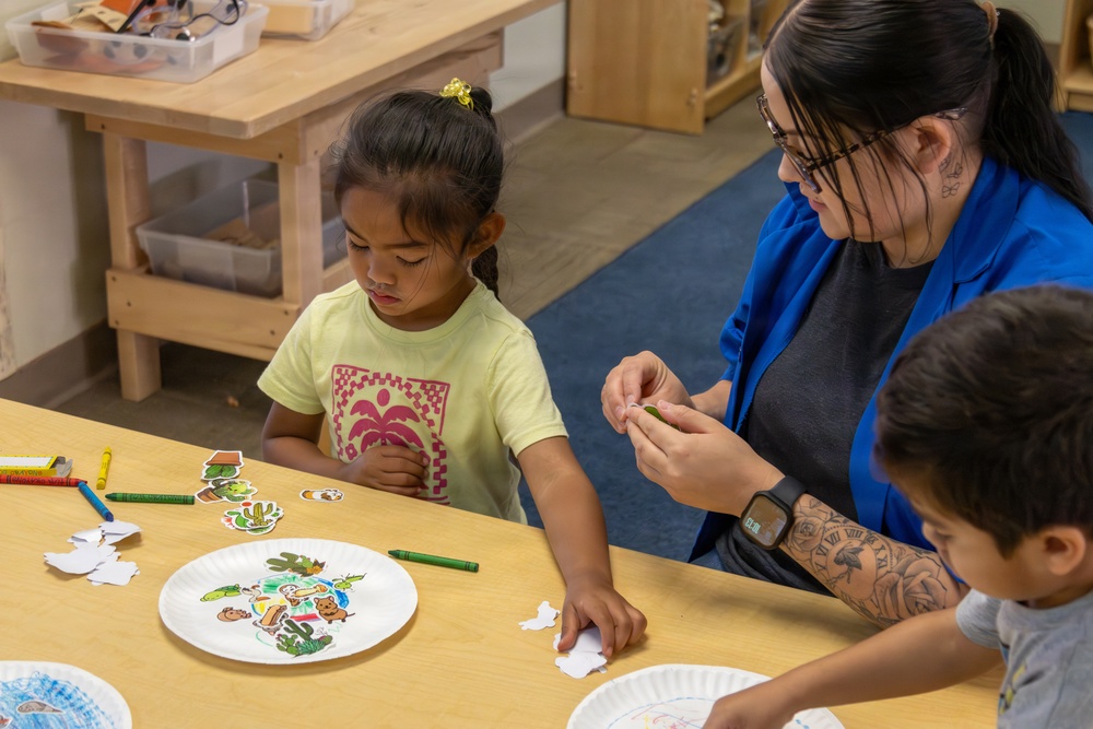 Children participate in Earth Day arts and crafts activities during an event hosted by Environmental