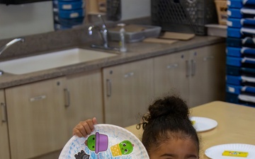 Child displays arts and crafts project at MCLB Barstow's Child Development Center