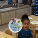 Child displays arts and crafts project at MCLB Barstow's Child Development Center