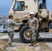 U.S. Sailors and U.S. Soldiers load lumber and ridge caps onto trucks