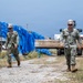U.S. Sailors and U.S. Soldiers load lumber and ridge caps onto trucks