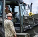U.S. Sailors and U.S. Soldiers load lumber and ridge caps onto trucks