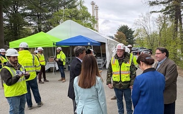 Officials and construction personnel gather at Topping Out Ceremony