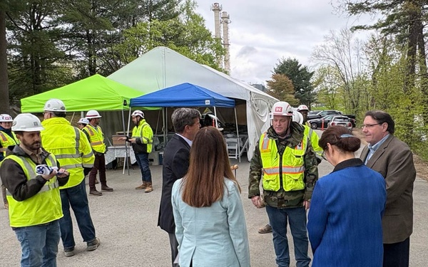 Officials and construction personnel gather at Topping Out Ceremony