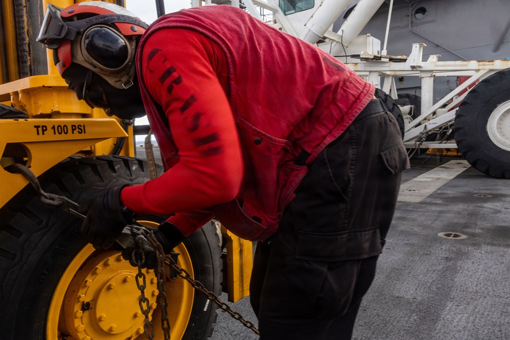 USS Iwo Jima Sailors Chain Down Equipment