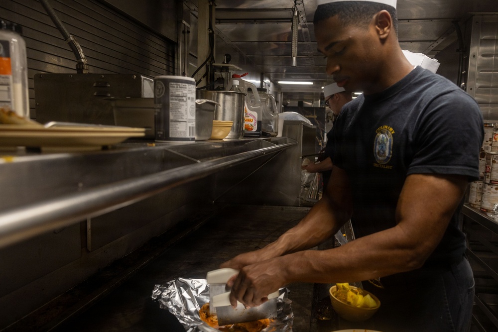 U.S. Navy Culinary Specialist Prepares Meal Aboard USS Iwo Jima