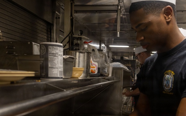 U.S. Navy Culinary Specialist Prepares Meal Aboard USS Iwo Jima