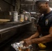 U.S. Navy Culinary Specialist Prepares Meal Aboard USS Iwo Jima