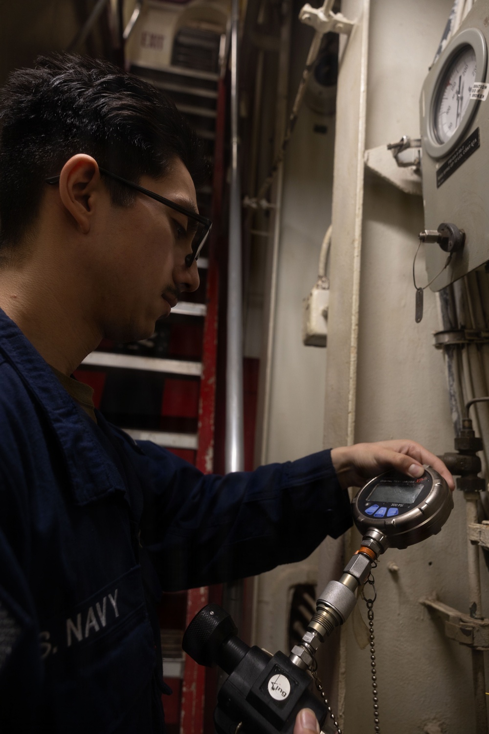 USS Iwo Jima Sailor Calibrates Equipment