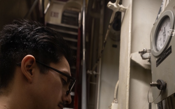 USS Iwo Jima Sailor Calibrates Equipment