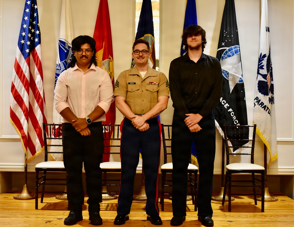 Marine Recruiter poses with his Poolees during signing day