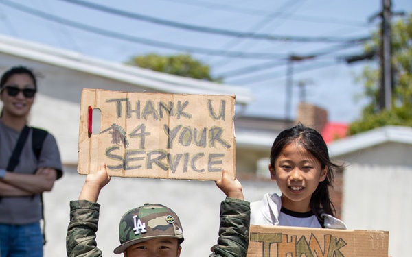 Children hold up signs at TAFDA26