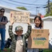Children hold up signs at TAFDA26