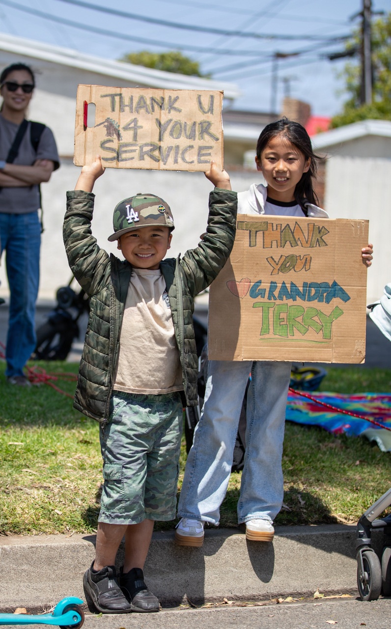 Children hold up signs at TAFDA26