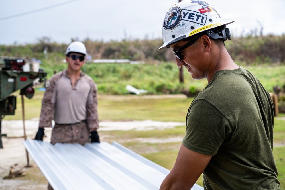 NMCB 1 Sailors and U.S. Marines conduct roof restoration operations in Tinian
