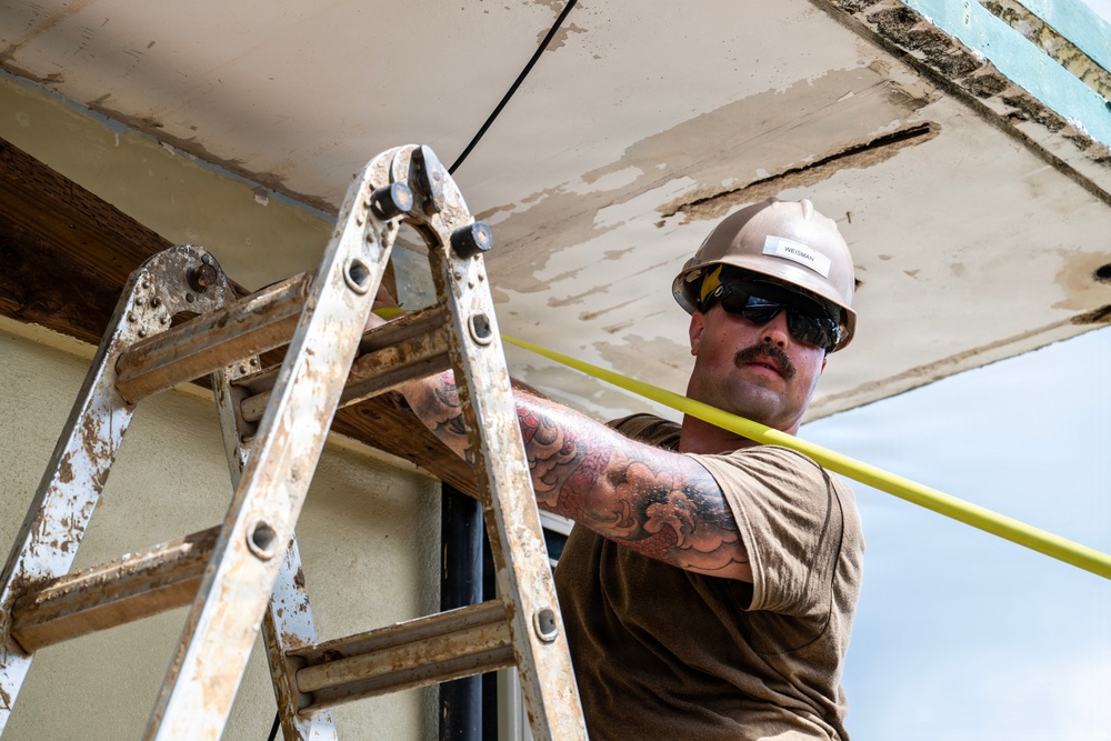 NMCB 1 Sailors and U.S. Marines conduct roof restoration operations in Tinian