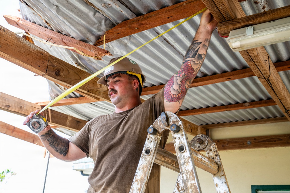 NMCB 1 Sailors and U.S. Marines conduct roof restoration operations in Tinian