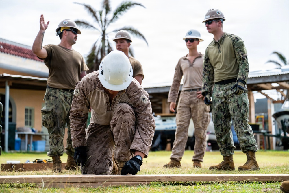 NMCB 1 Sailors and U.S. Marines conduct roof restoration operations in Tinian