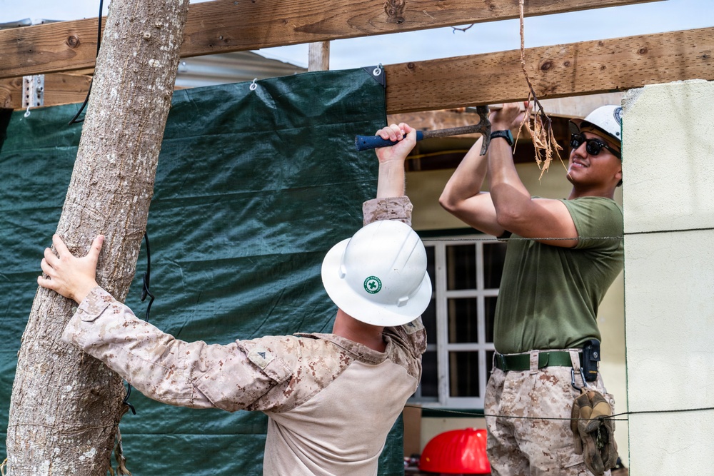 NMCB 1 Sailors and U.S. Marines conduct roof restoration operations in Tinian