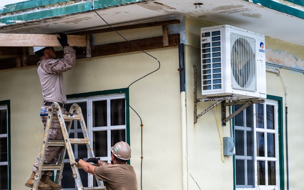 NMCB 1 Sailors and U.S. Marines conduct roof restoration operations in Tinian