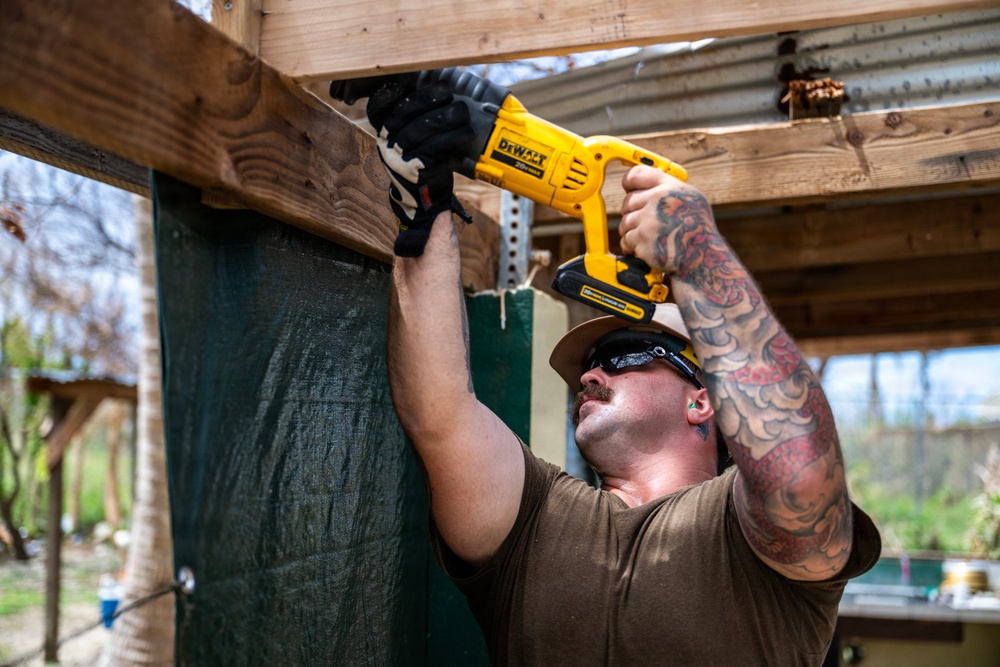 NMCB 1 Sailors and U.S. Marines conduct roof restoration operations in Tinian
