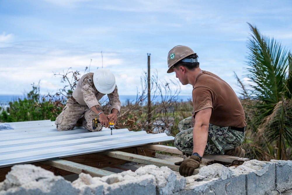 NMCB 1 Sailors and U.S. Marines conduct roof restoration operations in Tinian