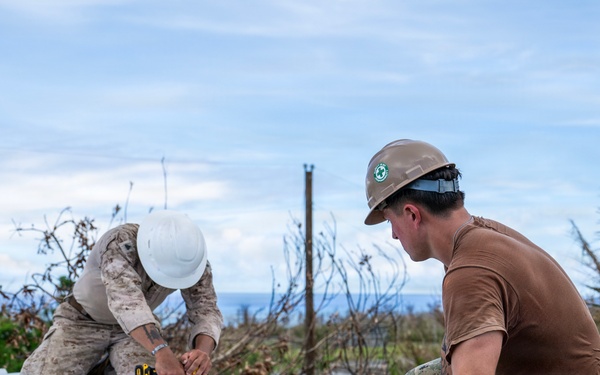 NMCB 1 Sailors and U.S. Marines conduct roof restoration operations in Tinian