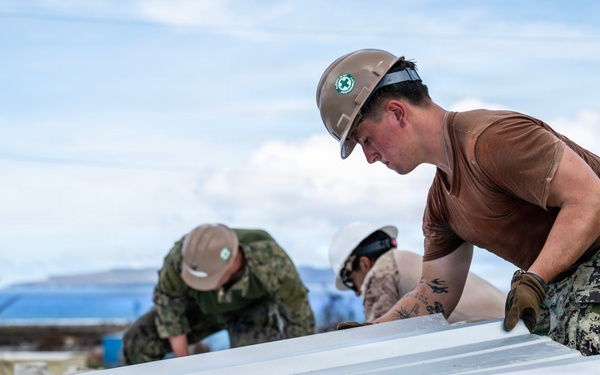 NMCB 1 Sailors and U.S. Marines conduct roof restoration operations in Tinian
