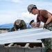 NMCB 1 Sailors and U.S. Marines conduct roof restoration operations in Tinian
