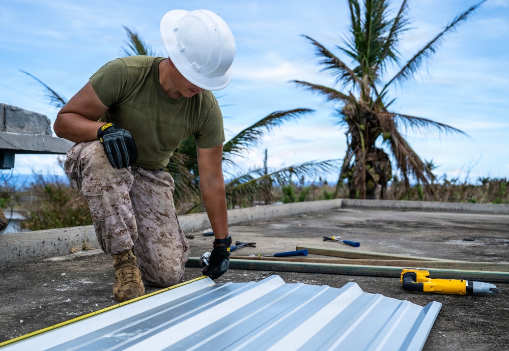 NMCB 1 Sailors and U.S. Marines conduct roof restoration operations in Tinian