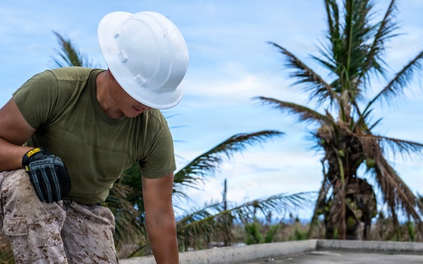 NMCB 1 Sailors and U.S. Marines conduct roof restoration operations in Tinian