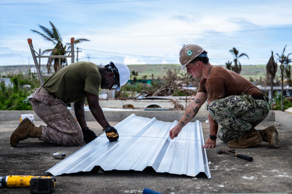 NMCB 1 Sailors and U.S. Marines conduct roof restoration operations in Tinian