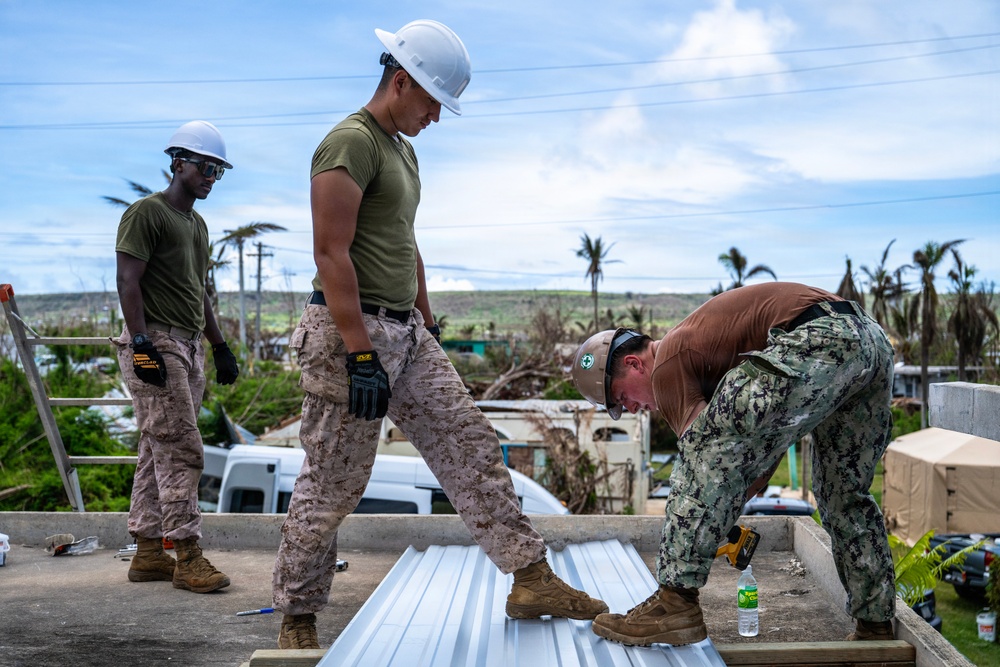 NMCB 1 Sailors and U.S. Marines conduct roof restoration operations in Tinian