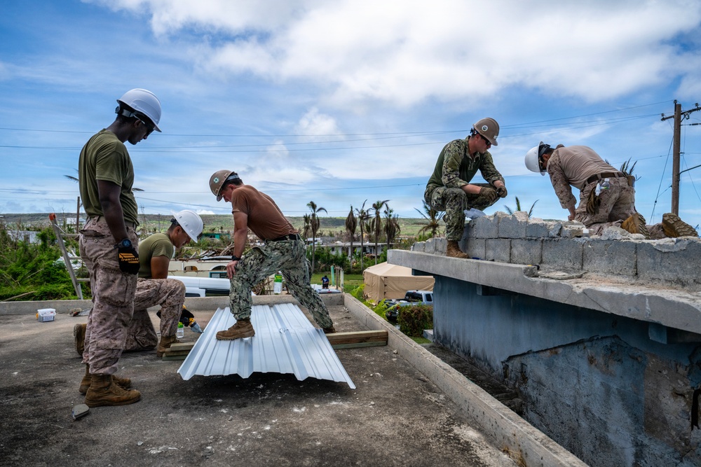NMCB 1 Sailors and U.S. Marines conduct roof restoration operations in Tinian