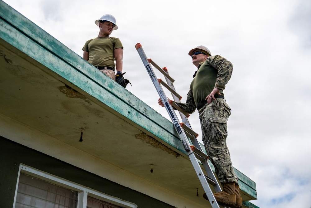 NMCB 1 Sailors and U.S. Marines conduct roof restoration operations in Tinian