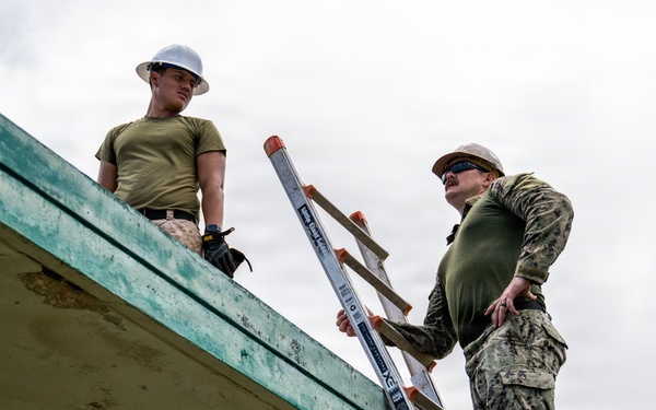 NMCB 1 Sailors and U.S. Marines conduct roof restoration operations in Tinian