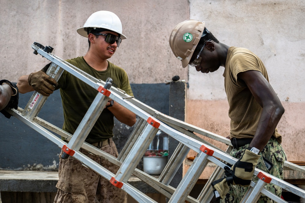 NMCB 1 Sailors and U.S. Marines conduct roof restoration operations in Tinian