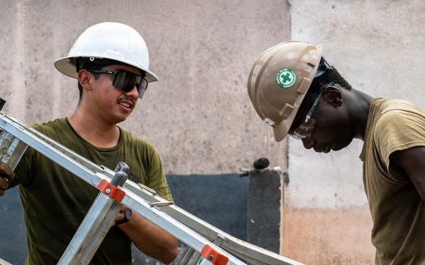 NMCB 1 Sailors and U.S. Marines conduct roof restoration operations in Tinian