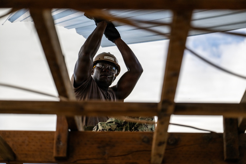 NMCB 1 Sailors and U.S. Marines conduct roof restoration operations in Tinian