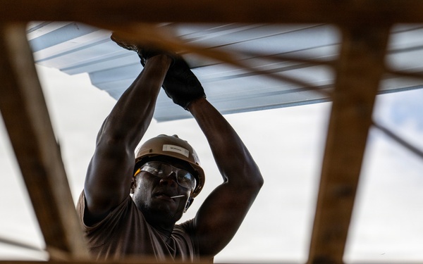 NMCB 1 Sailors and U.S. Marines conduct roof restoration operations in Tinian