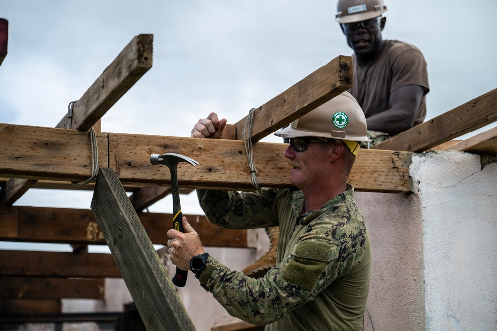 NMCB 1 Sailors and U.S. Marines conduct roof restoration operations in Tinian