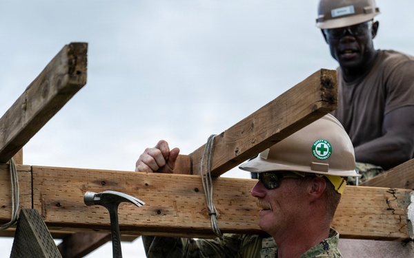 NMCB 1 Sailors and U.S. Marines conduct roof restoration operations in Tinian