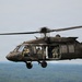 U.S. Army UH-60 Black Hawk helicopter crew conducts airborne operations over wooded terrain